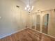 Dining room with wood-look flooring, chandelier, and wall mirrors at 7201 29Th Avenue W Dr # 306, Bradenton, FL 34209