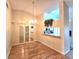 Open-concept dining room featuring wood-look flooring, a chandelier, and view into kitchen at 7201 29Th Avenue W Dr # 306, Bradenton, FL 34209