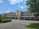 Exterior shot of the condo showing the balconies, covered parking, and landscaping at 7201 29Th Avenue W Dr # 306, Bradenton, FL 34209