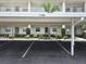 Exterior shot of building 3306 with well-maintained landscaping and assigned parking at 7201 29Th Avenue W Dr # 306, Bradenton, FL 34209