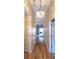 Hallway with wood floors, neutral walls, a decorative light fixture, and a glimpse into the living area at 7201 29Th Avenue W Dr # 306, Bradenton, FL 34209