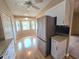 Bright kitchen features wood floors, stainless refrigerator, breakfast nook, and white cabinets at 7201 29Th Avenue W Dr # 306, Bradenton, FL 34209