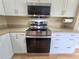 Kitchen featuring stainless steel appliances, white cabinetry, and light countertops at 7201 29Th Avenue W Dr # 306, Bradenton, FL 34209