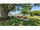 Charming picnic area featuring barbecue grills and several picnic tables beneath the shade of mature trees at 7201 29Th Avenue W Dr # 306, Bradenton, FL 34209