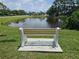 Scenic view of a tranquil pond from a cozy bench, perfect for relaxation and enjoying nature at 7201 29Th Avenue W Dr # 306, Bradenton, FL 34209