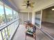 Bright sunroom with ceiling fan, comfortable seating, and sliding doors leading to additional living space at 7201 29Th Avenue W Dr # 306, Bradenton, FL 34209