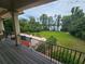 A covered veranda shows a spacious backyard with lush trees, grass and waterfront access at 7732 N Mobley Rd, Odessa, FL 33556