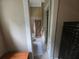 A narrow bathroom features a shower-tub combination with floral-patterned curtain at 7732 N Mobley Rd, Odessa, FL 33556