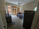 Bedroom with carpeted floors, ceiling fan, and large windows at 7732 N Mobley Rd, Odessa, FL 33556