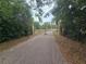Paver driveway behind a gate leading to the home through landscaped property at 7732 N Mobley Rd, Odessa, FL 33556