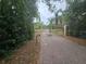 Wrought-iron driveway gate and paver driveway leading up to the home at 7732 N Mobley Rd, Odessa, FL 33556