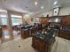 Gourmet kitchen featuring custom cabinets, granite countertops, and a large center island at 7732 N Mobley Rd, Odessa, FL 33556