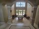 High ceilings and neutral tones welcome you into this living space featuring travertine tile flooring and a billiard table at 7732 N Mobley Rd, Odessa, FL 33556