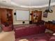 Basement theater room with projector, screen, reclining leather chairs, and bar area at 7732 N Mobley Rd, Odessa, FL 33556