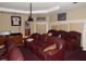 Large theater room featuring several reclining leather sofas, projector, and sports memorabilia at 7732 N Mobley Rd, Odessa, FL 33556