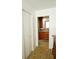 A view of the primary bathroom from the bedroom hall showcases wood cabinets and flooring at 802 Capri Isles Blvd # 231, Venice, FL 34292