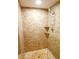 Walk-in shower featuring brown tile and a pebble floor at 802 Capri Isles Blvd # 231, Venice, FL 34292