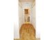 Hallway view of bathroom with wood floors, toilet, vanity, and ample closet space, offering functionality and storage at 802 Capri Isles Blvd # 231, Venice, FL 34292