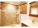 Bathroom features tiled walk-in shower, vanity, sink, and wooden cabinet storage, seamlessly combining luxury and function at 802 Capri Isles Blvd # 231, Venice, FL 34292