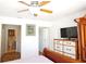 Bedroom with wood floors and view of the attached bathroom at 802 Capri Isles Blvd # 231, Venice, FL 34292