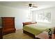 Bedroom featuring wood-look tile flooring, a ceiling fan and natural lighting at 802 Capri Isles Blvd # 231, Venice, FL 34292