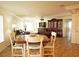 Dining area with wood-look tile flooring, a ceiling fan and adjacent living room at 802 Capri Isles Blvd # 231, Venice, FL 34292
