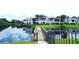 Exterior of a residential building overlooking a pond, accessed via a wooden bridge at 802 Capri Isles Blvd # 231, Venice, FL 34292