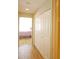 Bright hallway with wood floors and white closets, leading to a bedroom at 802 Capri Isles Blvd # 231, Venice, FL 34292