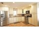 Kitchen area with stainless steel refrigerator, oven and range, and microwave at 802 Capri Isles Blvd # 231, Venice, FL 34292