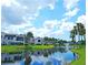 Scenic view of a pond with a fountain, surrounded by well-manicured lawns and palm trees at 802 Capri Isles Blvd # 231, Venice, FL 34292
