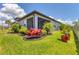 Well-manicured backyard featuring tropical plants and a cozy screened lanai at 8541 Whispering St, Sarasota, FL 34240