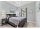 Comfortable bedroom with natural light, a cozy bed, and a serene atmosphere at 8541 Whispering St, Sarasota, FL 34240
