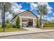 Community mail kiosk with a covered picnic area, manicured landscaping, and ample parking at 8541 Whispering St, Sarasota, FL 34240