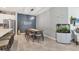 Stylish dining area featuring modern lighting, a dining table, and a beautiful aquarium at 8541 Whispering St, Sarasota, FL 34240