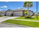 Attractive home exterior with a gray facade, a double garage, and vibrant landscaping at 8541 Whispering St, Sarasota, FL 34240