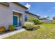 Charming home exterior featuring a blue front door, well-manicured landscaping, and a welcoming walkway at 8541 Whispering St, Sarasota, FL 34240