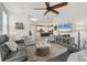 Open-concept living room flowing into the kitchen with a large TV and comfortable seating arrangements at 8541 Whispering St, Sarasota, FL 34240