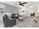 Comfortable living room featuring stylish seating, a ceiling fan, and elegant blue-patterned wallpaper at 8541 Whispering St, Sarasota, FL 34240