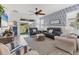Comfortable living room with stylish seating, a ceiling fan, and access to an outdoor view at 8541 Whispering St, Sarasota, FL 34240