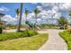 A new playground on a manicured lawn with palm trees and a curving sidewalk is a great way to enjoy some exercise at 8541 Whispering St, Sarasota, FL 34240