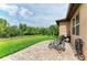 Paver patio with chairs, lush lawn, and fence line create a private backyard oasis at 10708 52Nd E Ct, Parrish, FL 34219