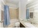 Cozy bathroom featuring granite countertop, mirror, and blue shower curtain at 10708 52Nd E Ct, Parrish, FL 34219