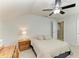 Bright bedroom featuring a ceiling fan, large bed, bedside table, and a door leading to a hallway at 10708 52Nd E Ct, Parrish, FL 34219