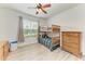 Bright bedroom with bunk beds, ceiling fan, wood-look flooring and window view at 10708 52Nd E Ct, Parrish, FL 34219