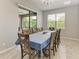Open-concept dining room with a large table, chair seating for eight, and lots of natural light at 10708 52Nd E Ct, Parrish, FL 34219