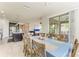 Open-concept dining room with a large table, chair seating for eight, and views of the kitchen and living room at 10708 52Nd E Ct, Parrish, FL 34219