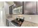 Close up of kitchen featuring granite countertops, stainless steel appliances, tile backsplash, and dark wood cabinets at 10708 52Nd E Ct, Parrish, FL 34219