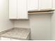 Bright laundry room with white cabinets, a countertop, and a hanging rod for added convenience at 10708 52Nd E Ct, Parrish, FL 34219