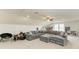 Spacious living room with large sectional sofa and ceiling fan at 10708 52Nd E Ct, Parrish, FL 34219