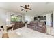 Open-concept living room with tile floors that connects to the kitchen area at 10708 52Nd E Ct, Parrish, FL 34219